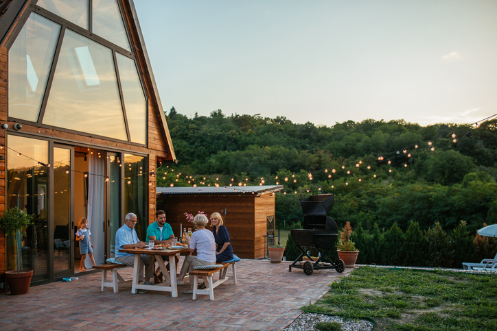 Family dinner around dining table in the garden